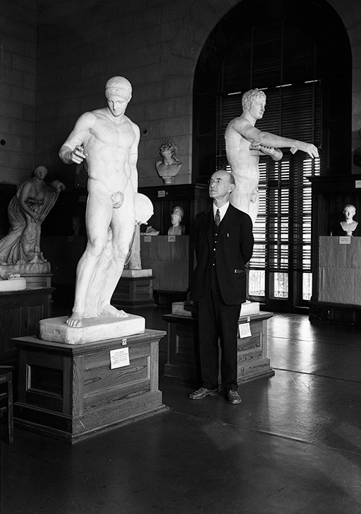 William Battle stands in front of casts of the Discobolos and the Apoxyomenos in a 1936 display in Battle Hall